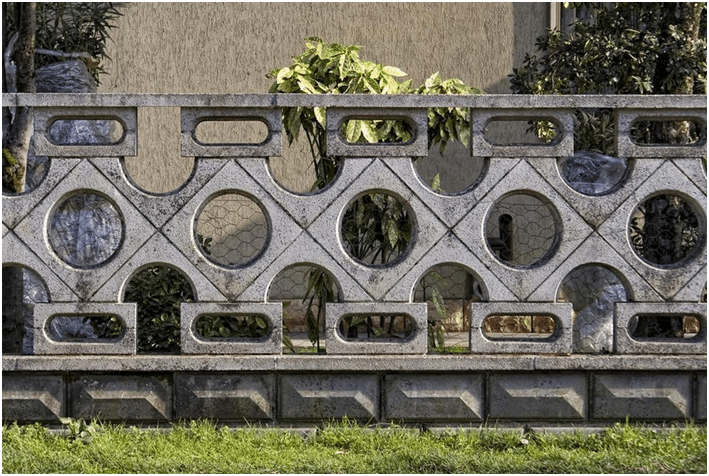 Modern Concrete Fence Featuring Geometric Patterns.